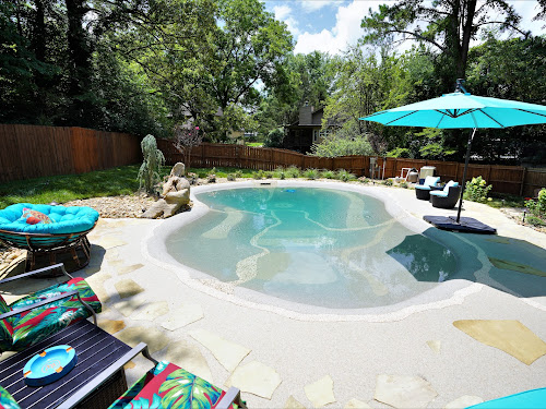 Finished sand sculpted pool with beach entry and flagstone patio