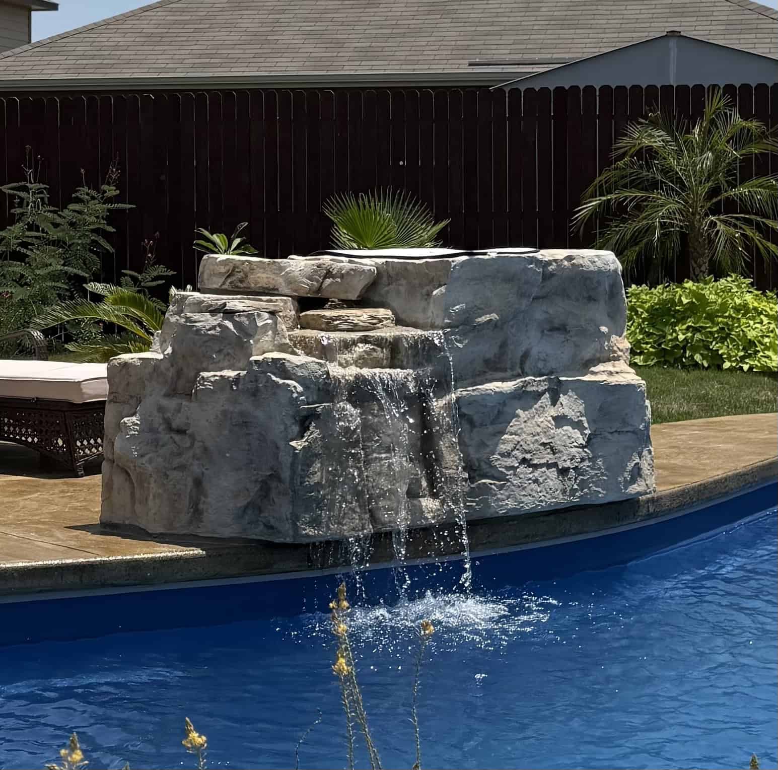 Jump Rocks cast rock feature installed on a pool