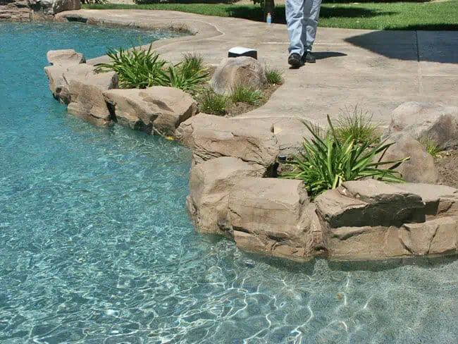 Seating Boulders cast rock feature installed on a pool