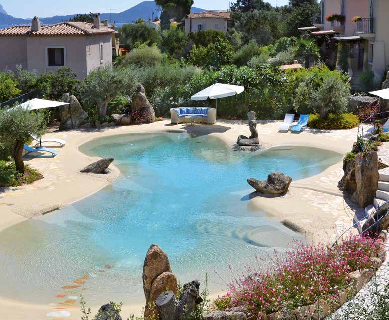Sand sculpted natural swimming pool with a walk-in beach entry and boulder edging