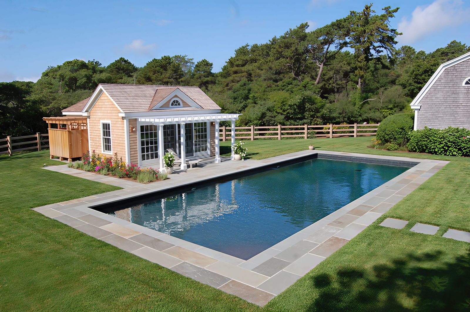 Lap pool beside a pool house