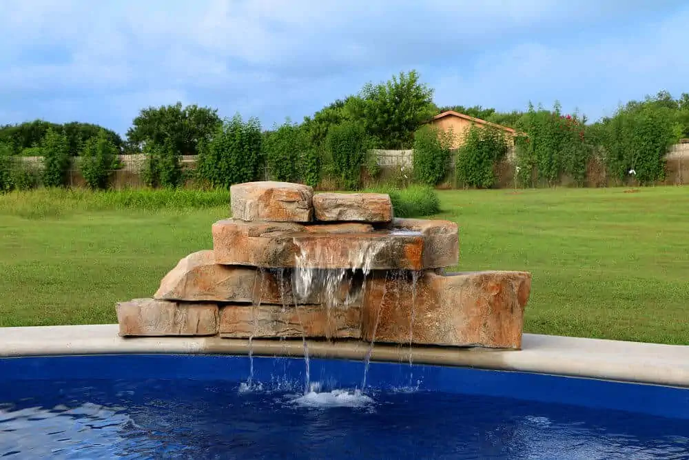 Creek Step cast rock feature installed on a pool