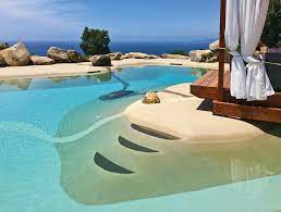 Sand sculpted pool with sculpted lounge shelf and beach entry
