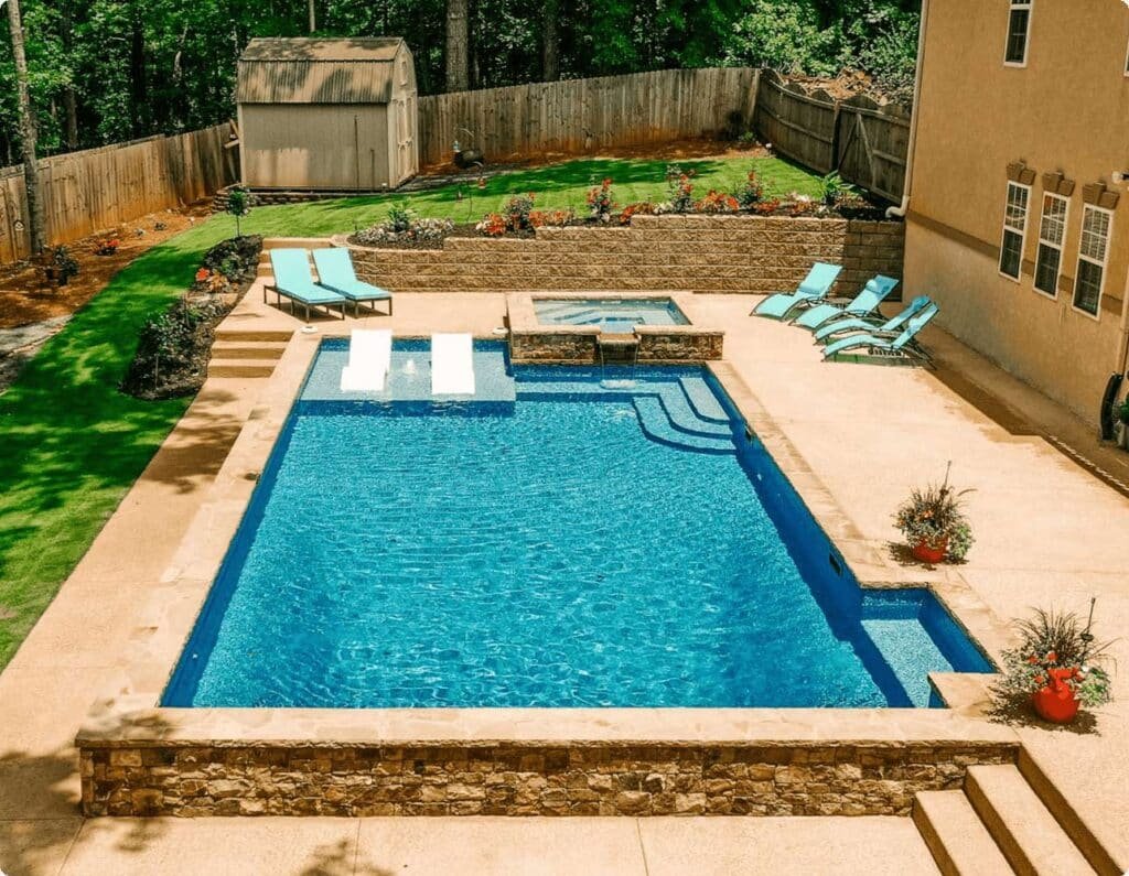 Vinyl liner pool with a wide built-in tanning ledge and patio