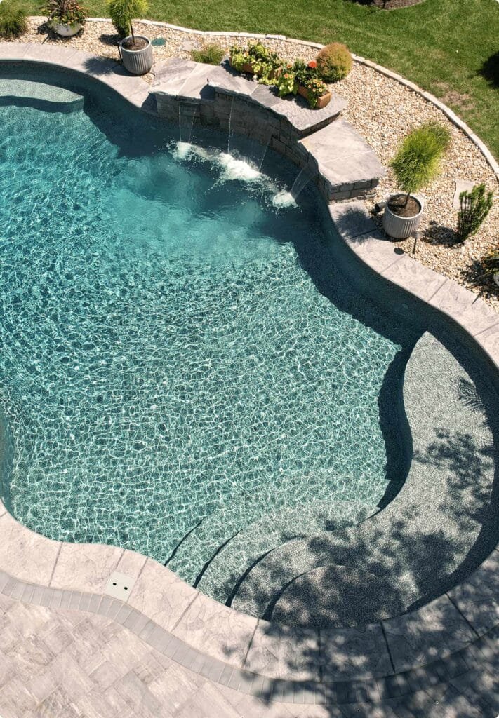 Pool tanning ledge with integrated steps and railings