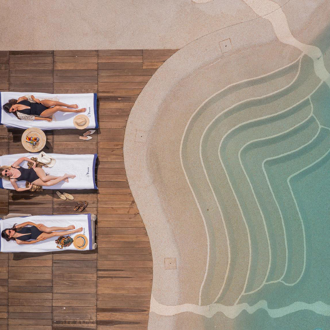 Family enjoying the shallow beach of a Bio.design pool