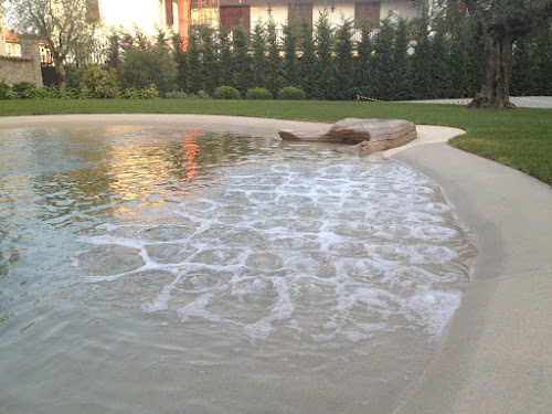 Shallow sculpted beach of a sand sculpted pool at golden hour